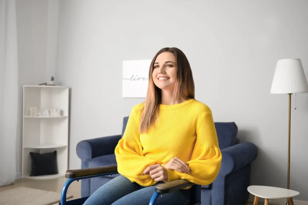 Disabled woman in wheelchair sitting in living room